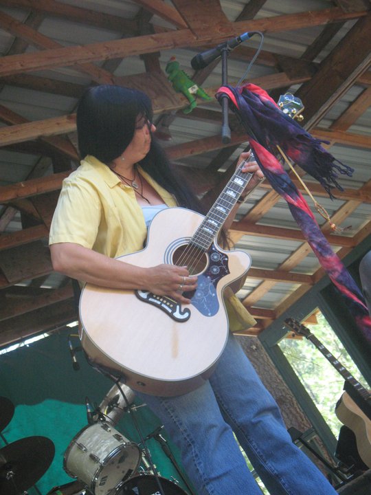 FaeRaven playing a Gibson J-200 acoustic guitar