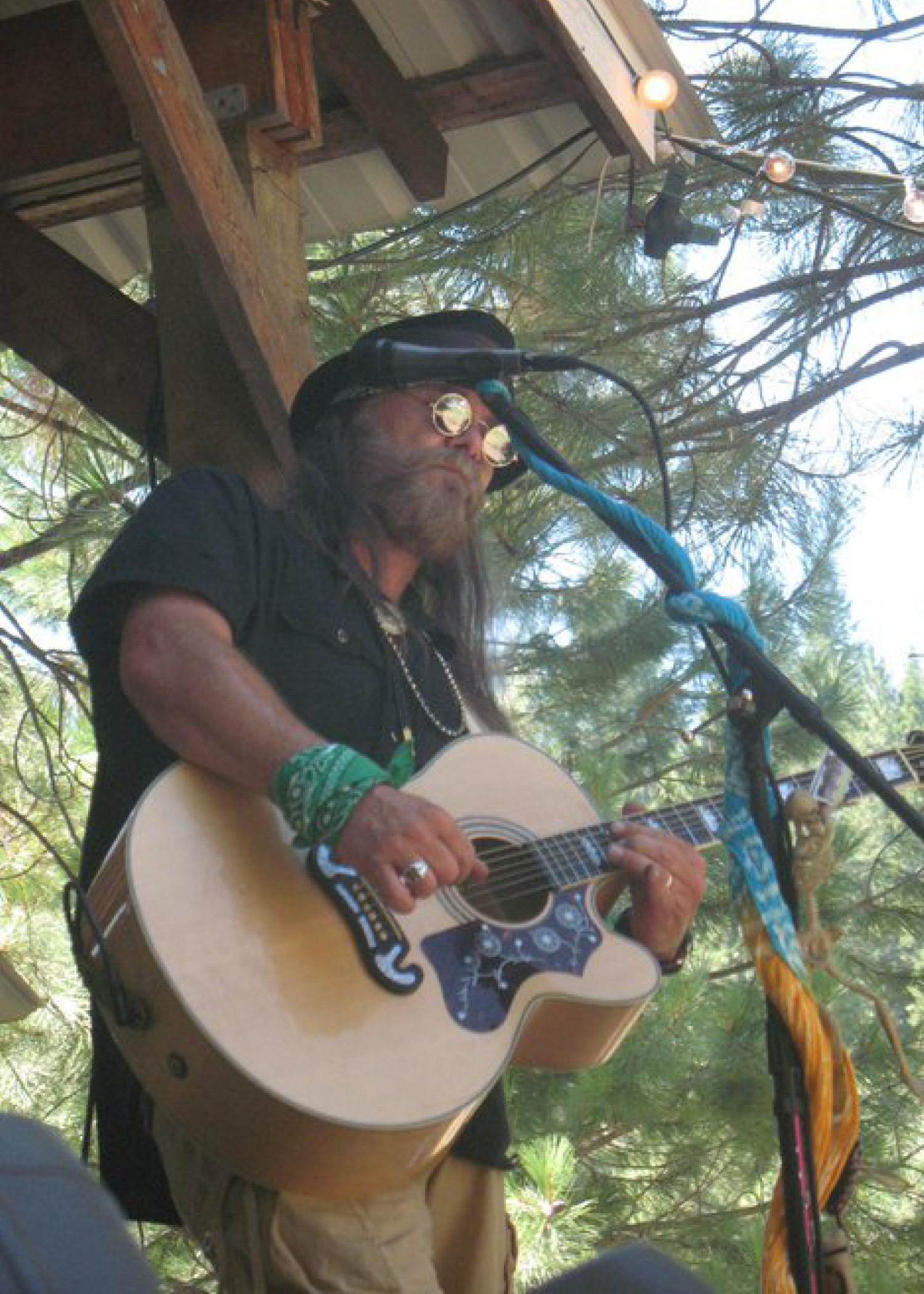 Jamey Bilyeu playing acoustic guitar on stage